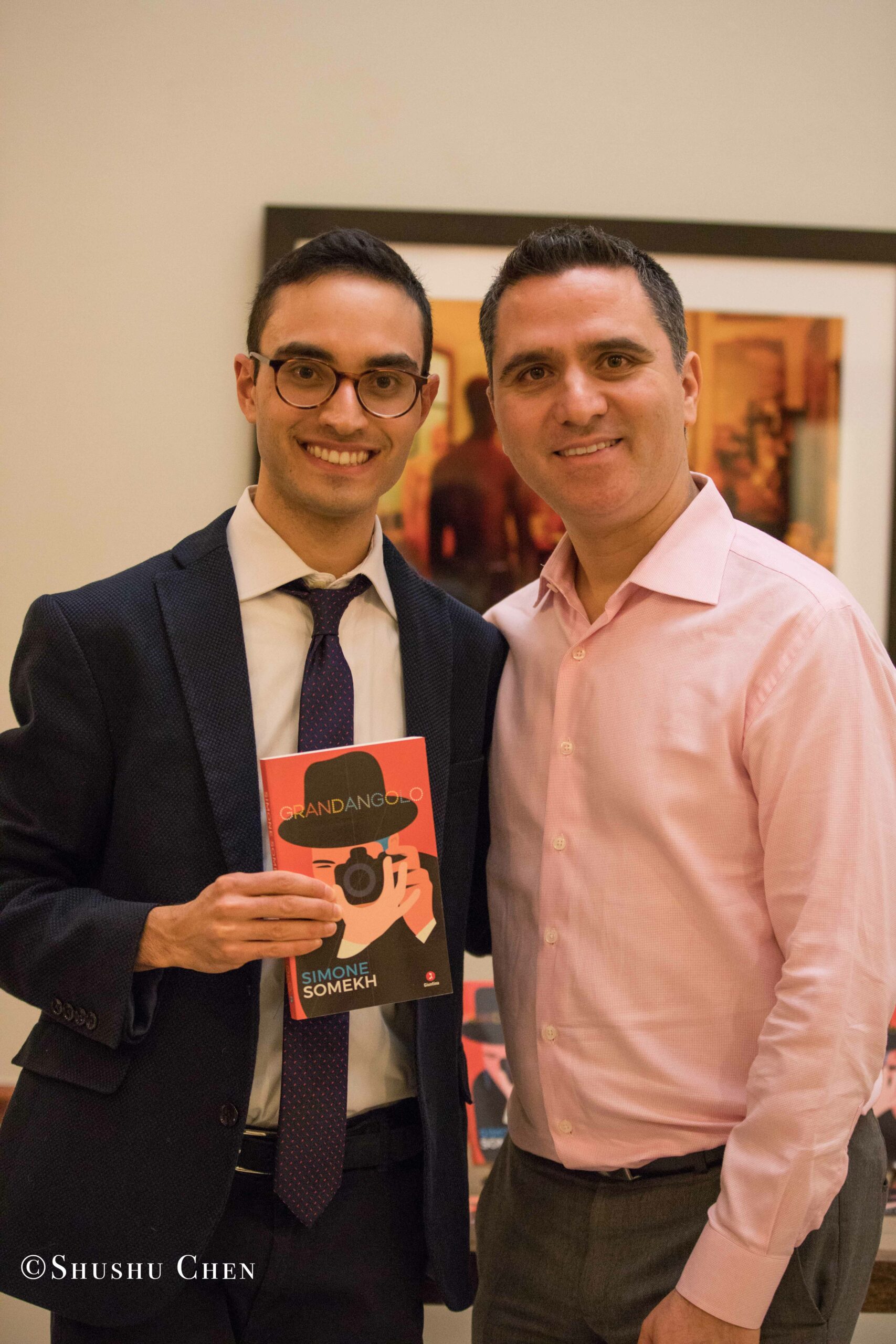 author-and-man-smiling-with-book-from-book-presentation-grandangolo-at-casa-italiana