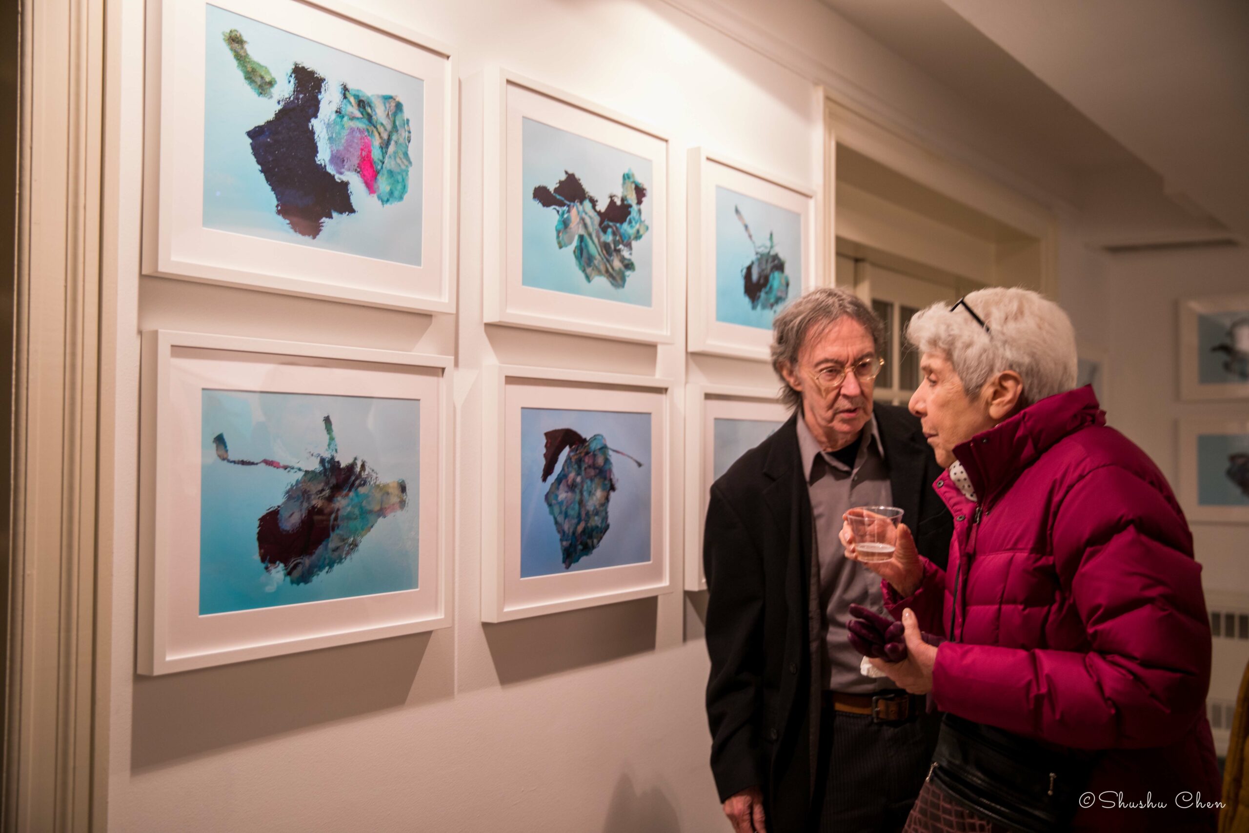 guests-conversing-and-artworks-on-wall-from-exhibition-migration-at-casa-italiana