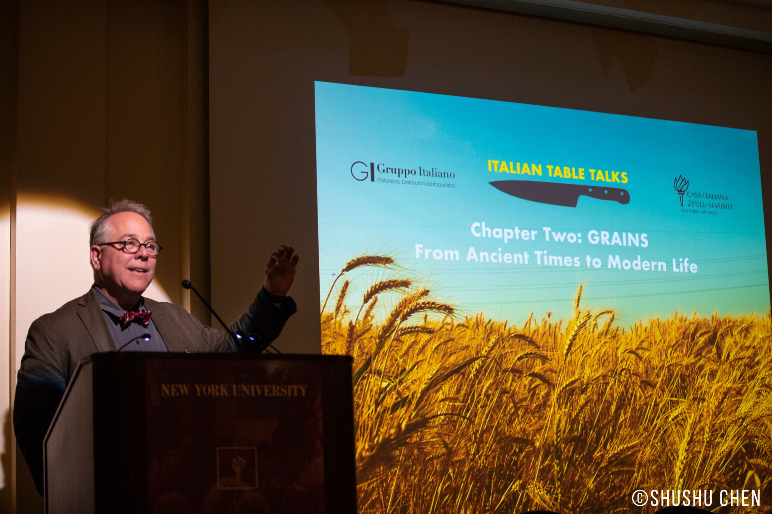 speaker-talking-image-being-displayed-on-projector-screen-from-italian-table-talks-grains-at-casa-italiana
