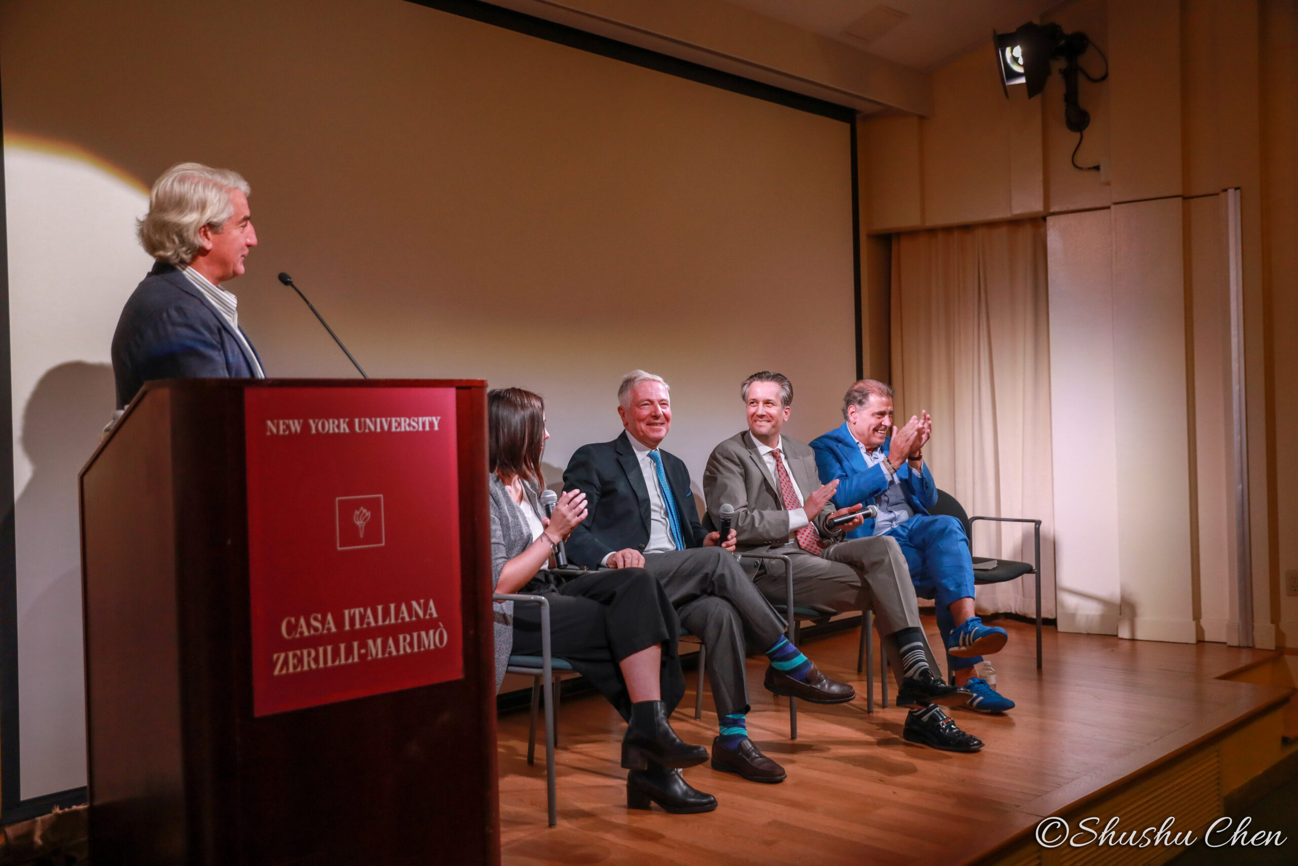 speaker-talking-and-other-speakers-clapping-from-globalization-vs-authenticity-at-casa-italiana