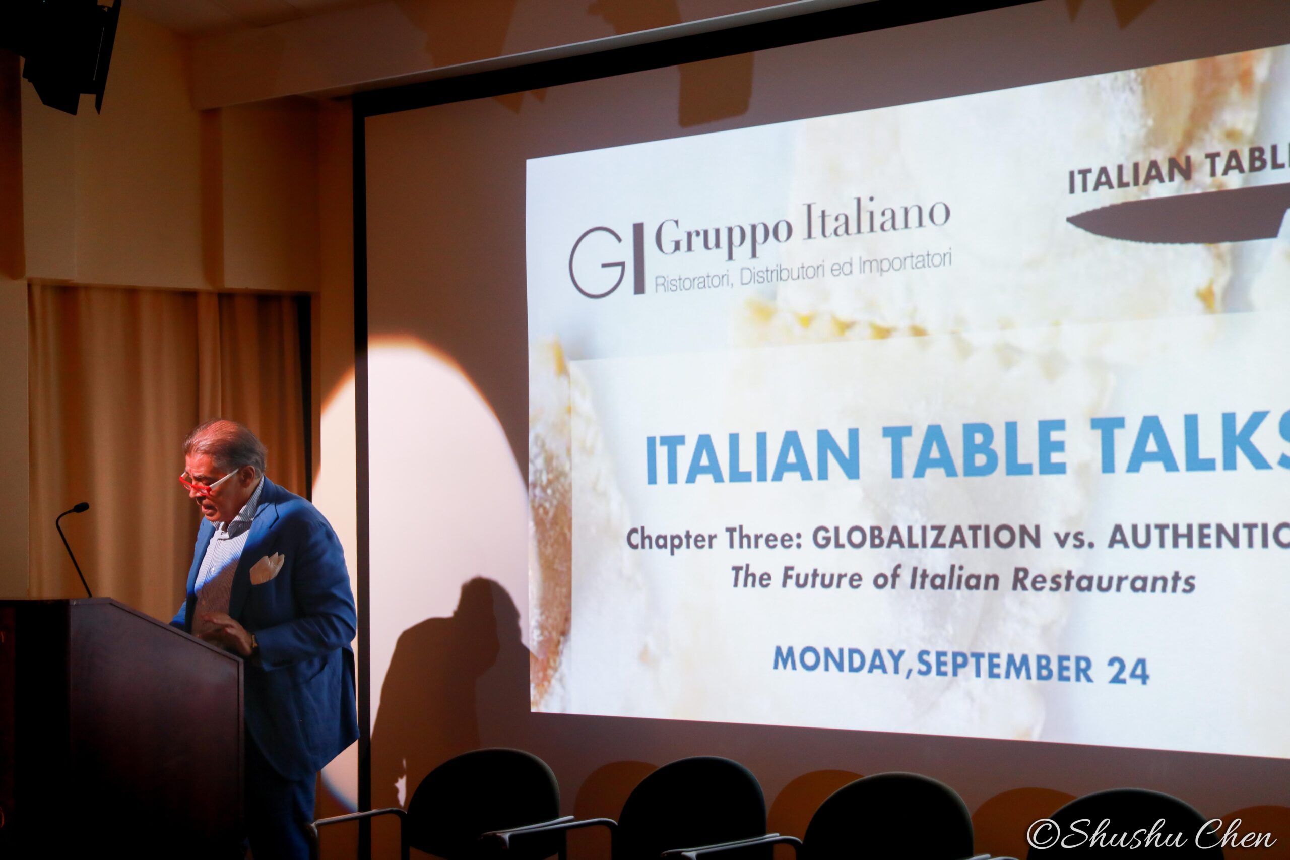 speaker-talking-and-image-being-displayed-on-projector-screen-from-globalization-vs-authenticity-at-casa-italiana