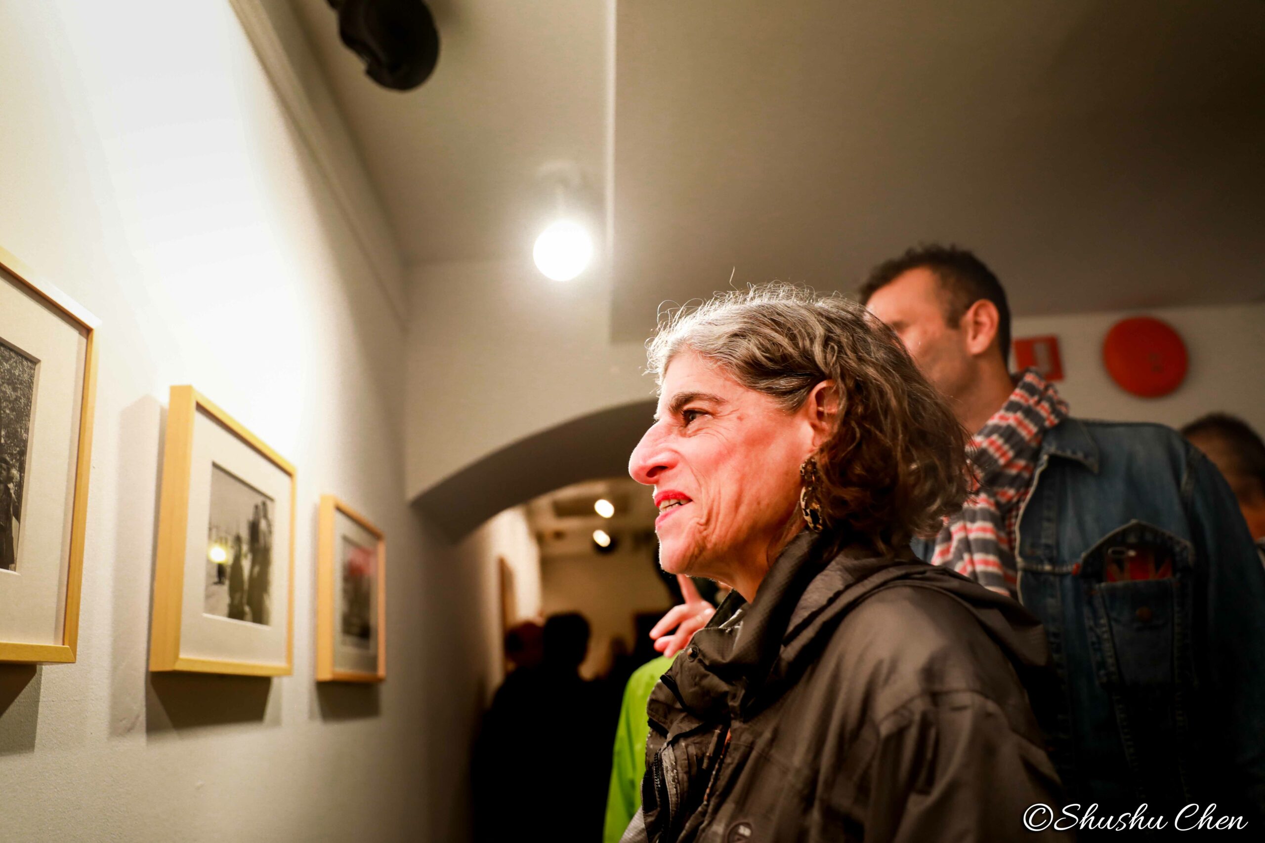 woman-seeing-artwork-on-wall-from-neorealism-and-photography-at-casa-italiana