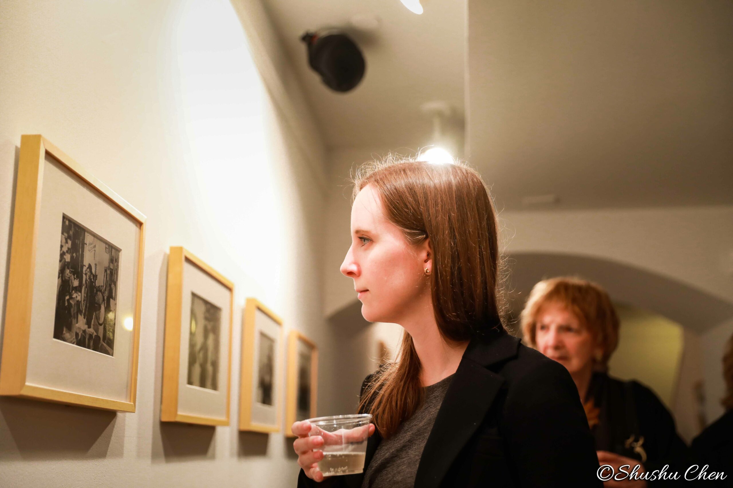 woman-seeing-artwork-on-wall-from-neorealism-and-photography-at-casa-italiana
