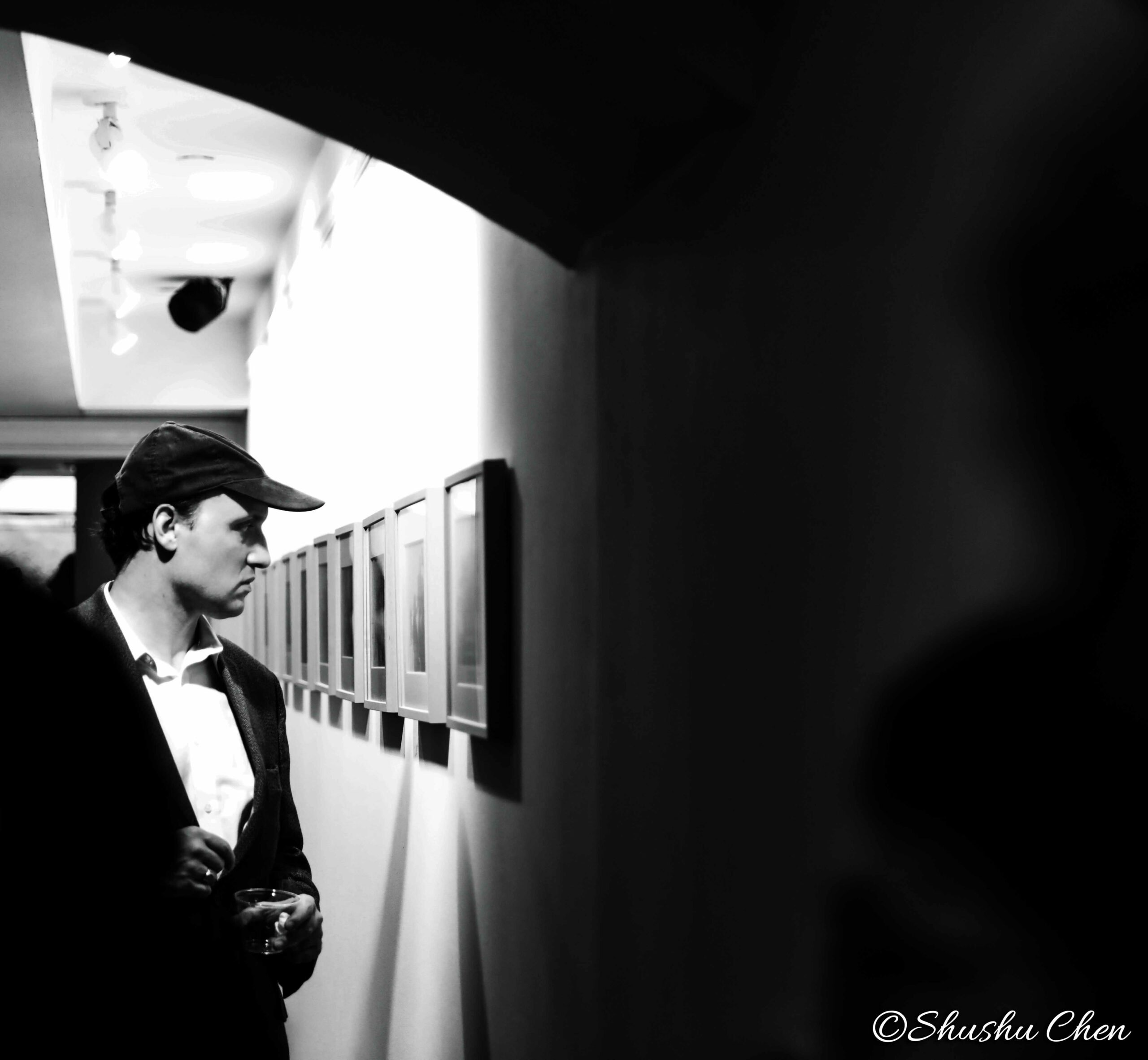 man-seeing-artwork-on-wall-from-neorealism-and-photography-at-casa-italiana
