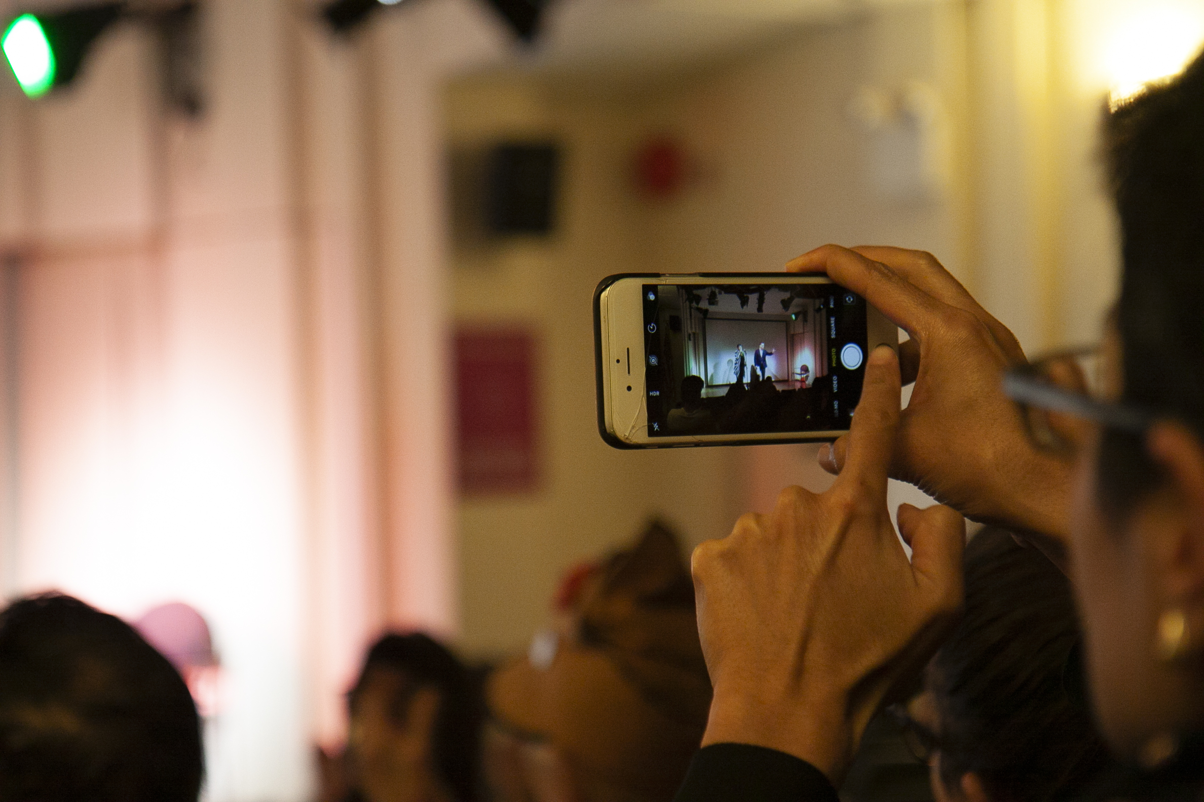 spectator-taking-picture-from-versetto-libero-italian-artists-meet-nyc-poets-at-casa-italiana