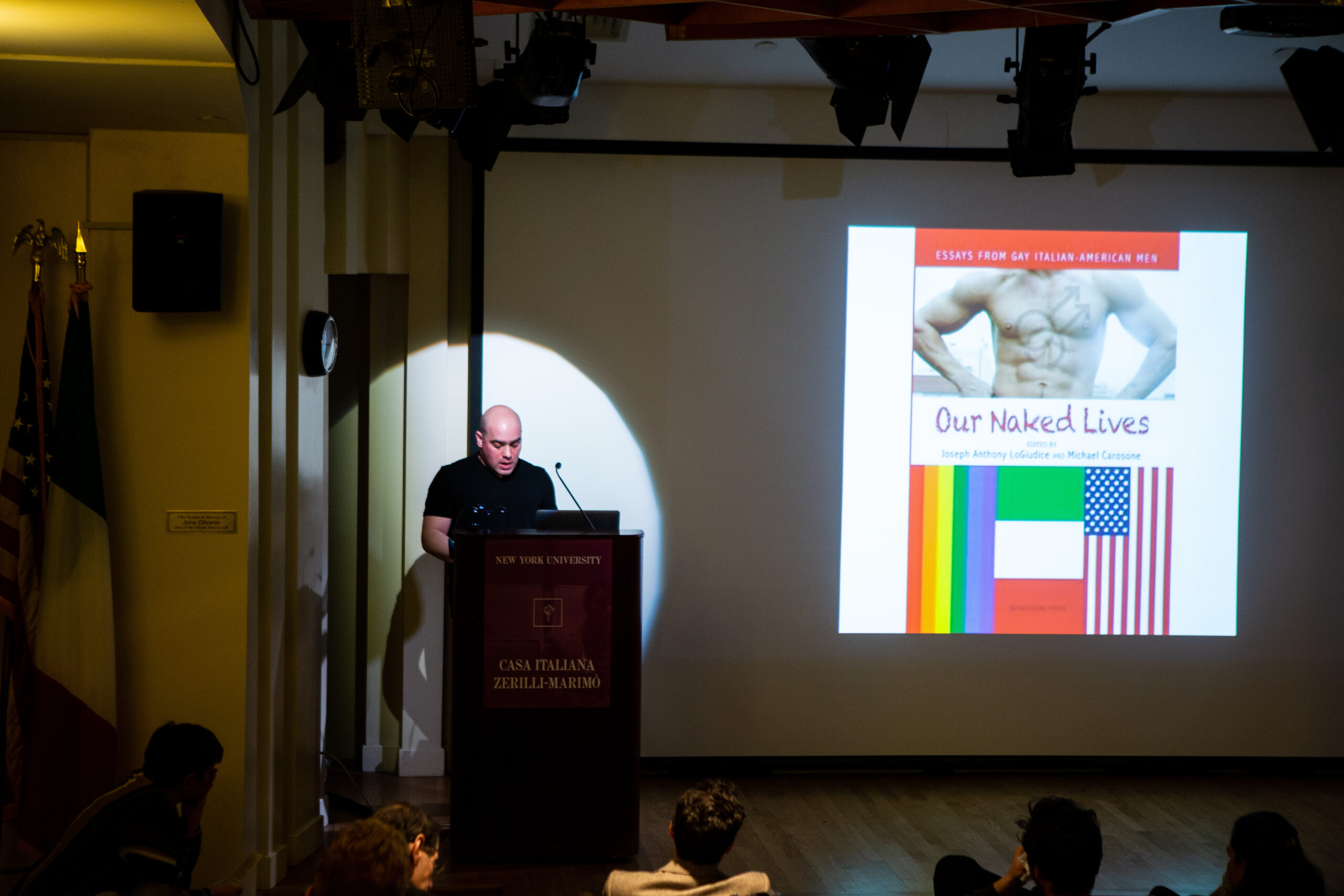 speaker-talking-and-image-being-displayed-on-the-projector-screen-from-lgbtq-in-italian-american-theater-at-casa-italiana