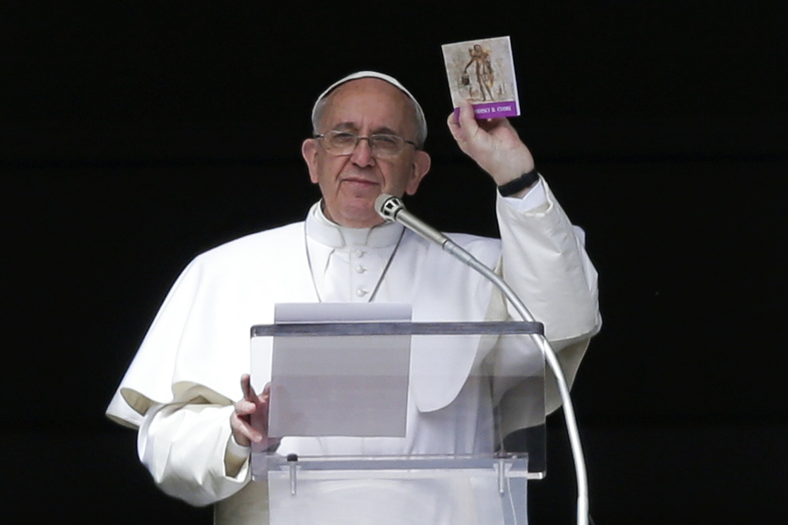 photo of Pope Francis holding a book